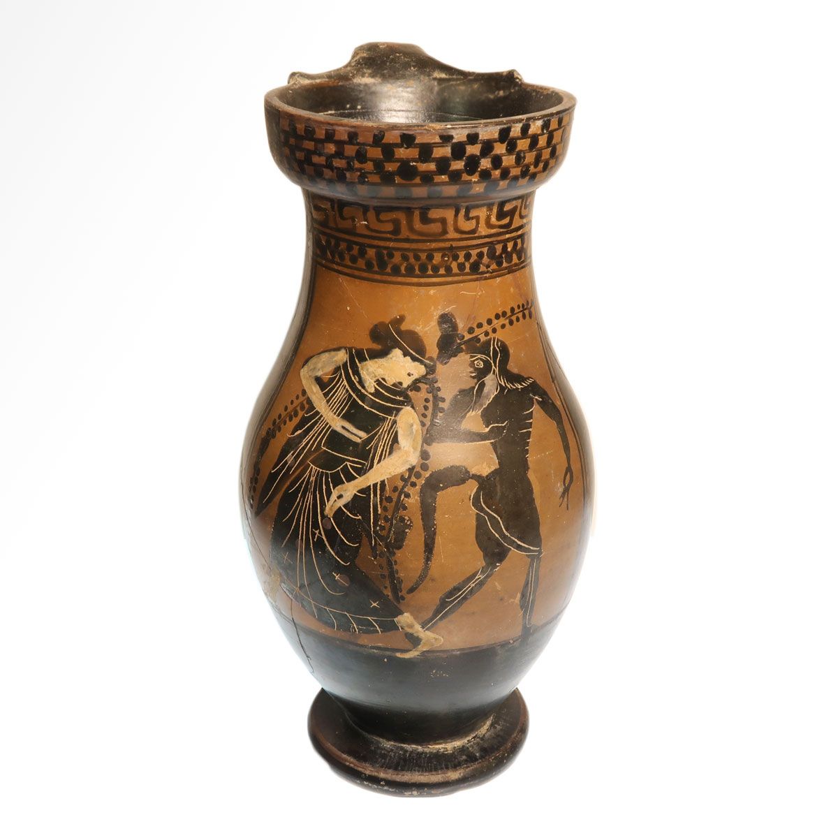 Attic black-figure olpe seen from the front: a satyr and a maenad face each other on the belly, with a meander band and rows of dots at the neck, on a torus foot.