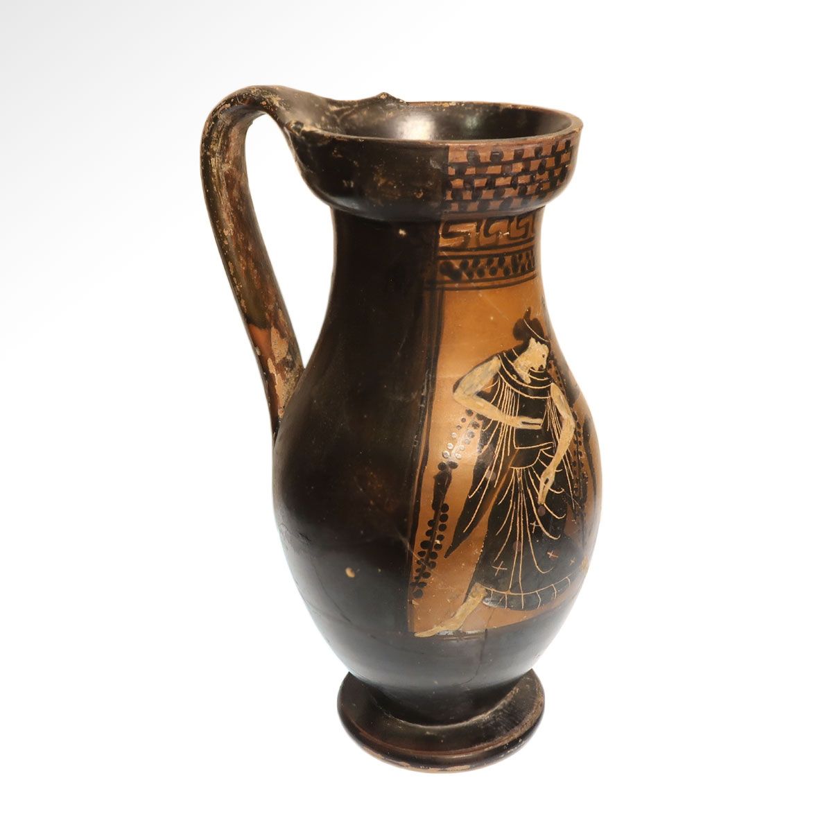 The same olpe from the side, showing the strap handle rising above the trefoil mouth and the plain black-gloss back.
