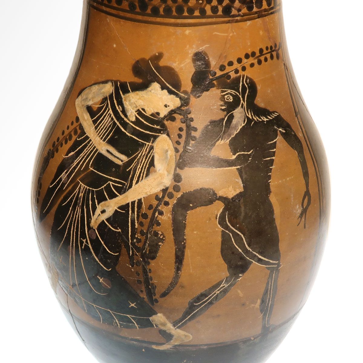 Detail of the komos: the maenad in a patterned chiton facing the satyr, the figures drawn with incised lines and added white.